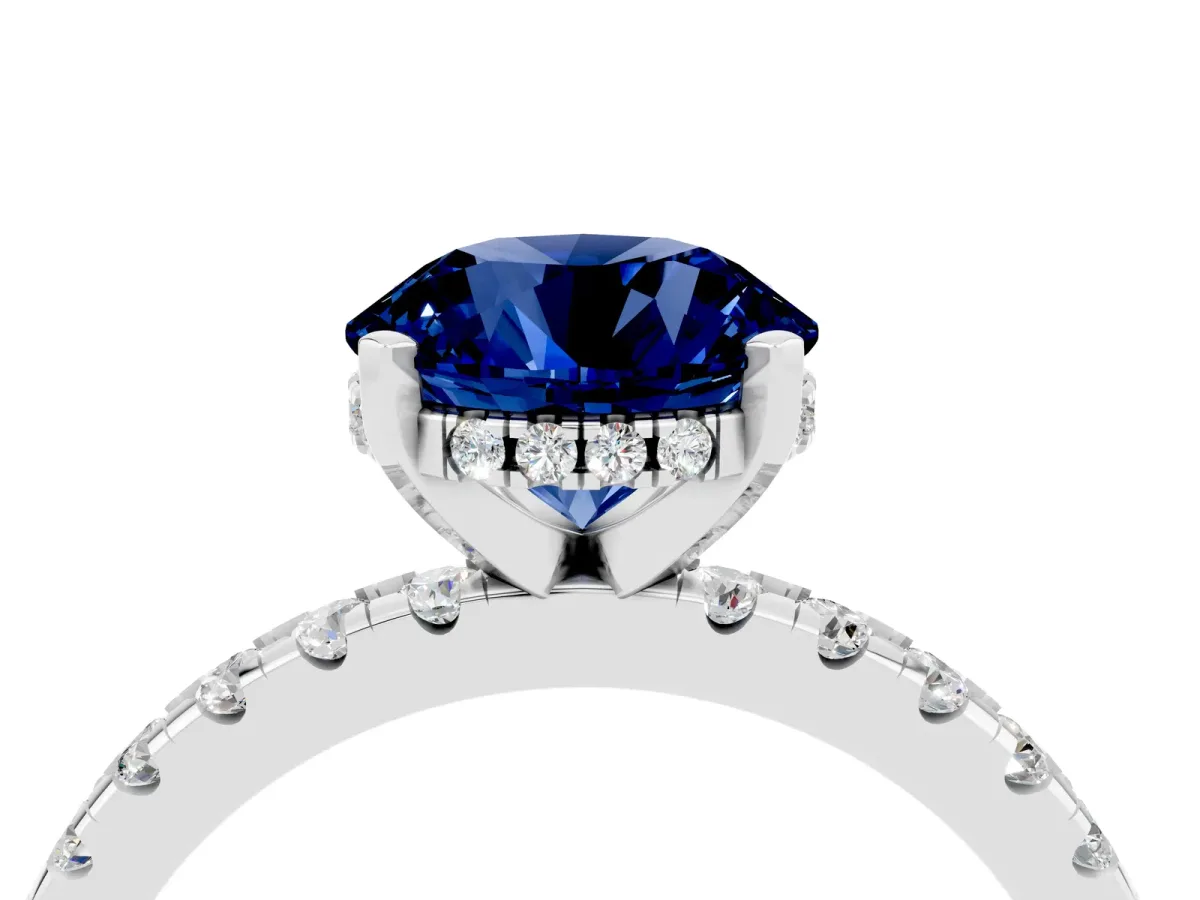 Round Cut Blue Sapphire Solitaire Ring with Round Pavé Band and Four-Prong Setting Silver
