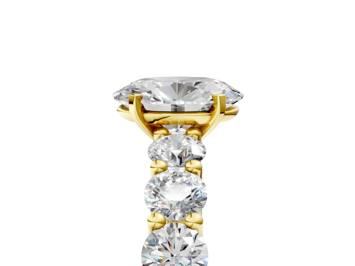 Oval Cut Diamond Prong Setting with Side Stones on a Pave Band Yellow gold