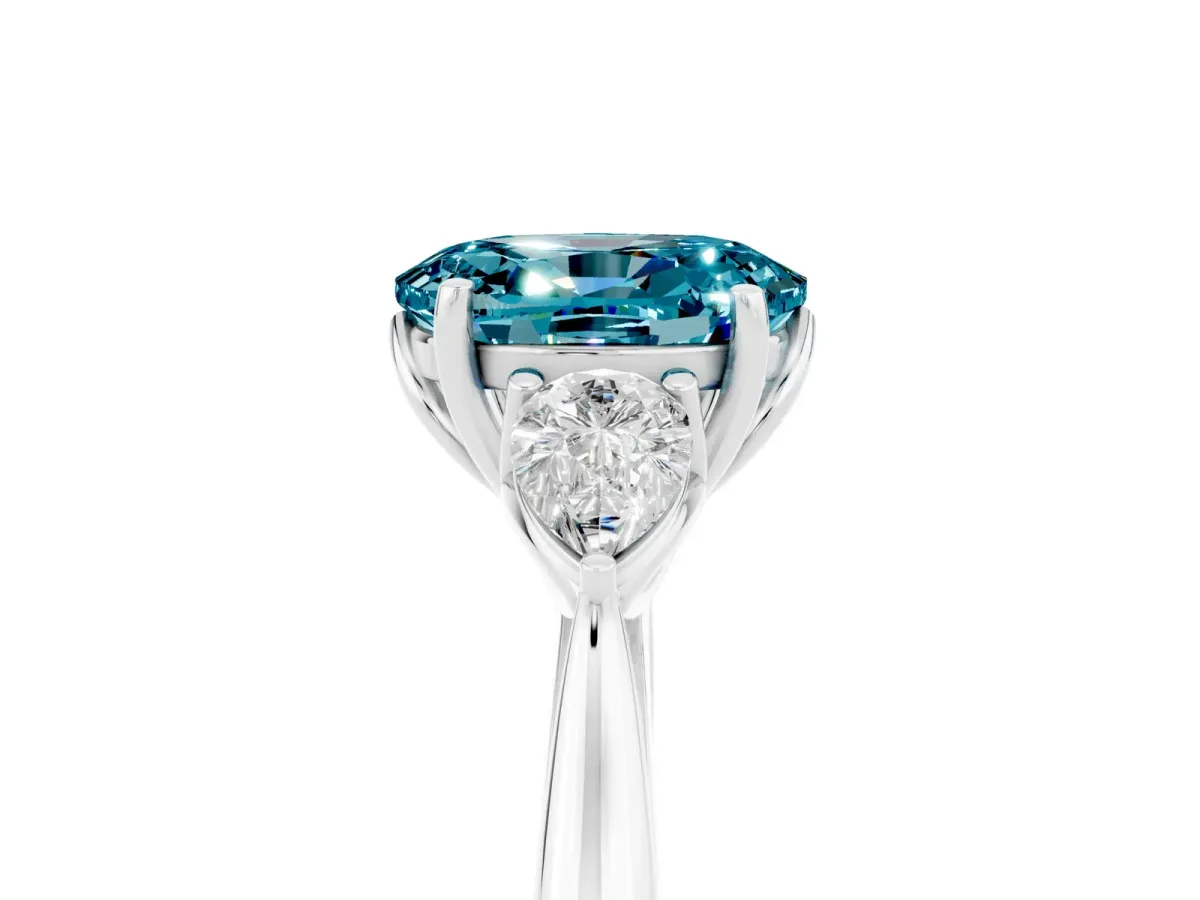 Three-Stone Oval Cut Blue Topaz Ring with Pear Side Stones in Four-Prong Setting White gold