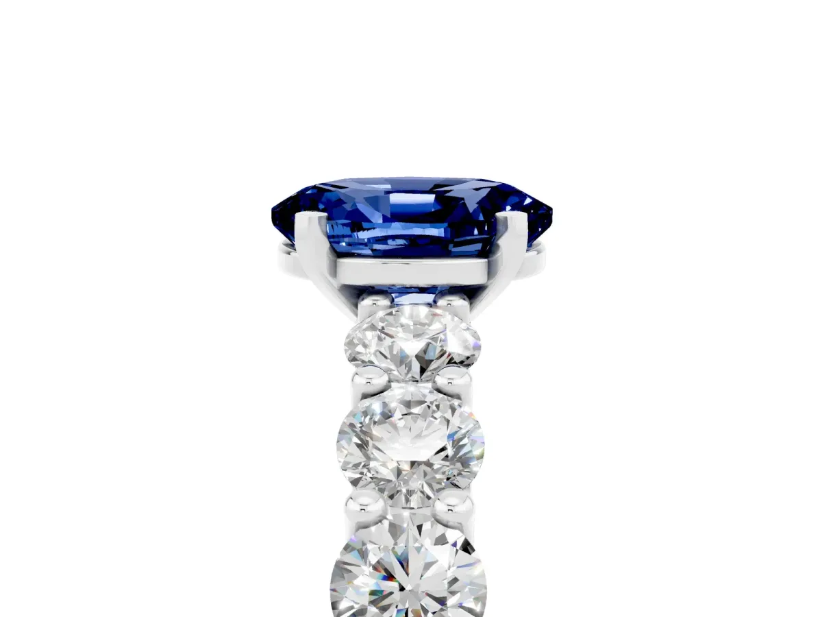 Oval Cut Blue Sapphire Prong Setting with Side Stones on a Pave Band Silver