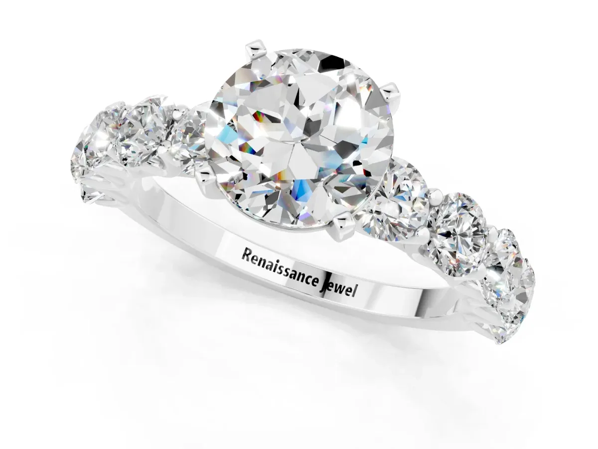 Round Cut Moissanite Prong Setting with Side Stones on a Pave Band Silver