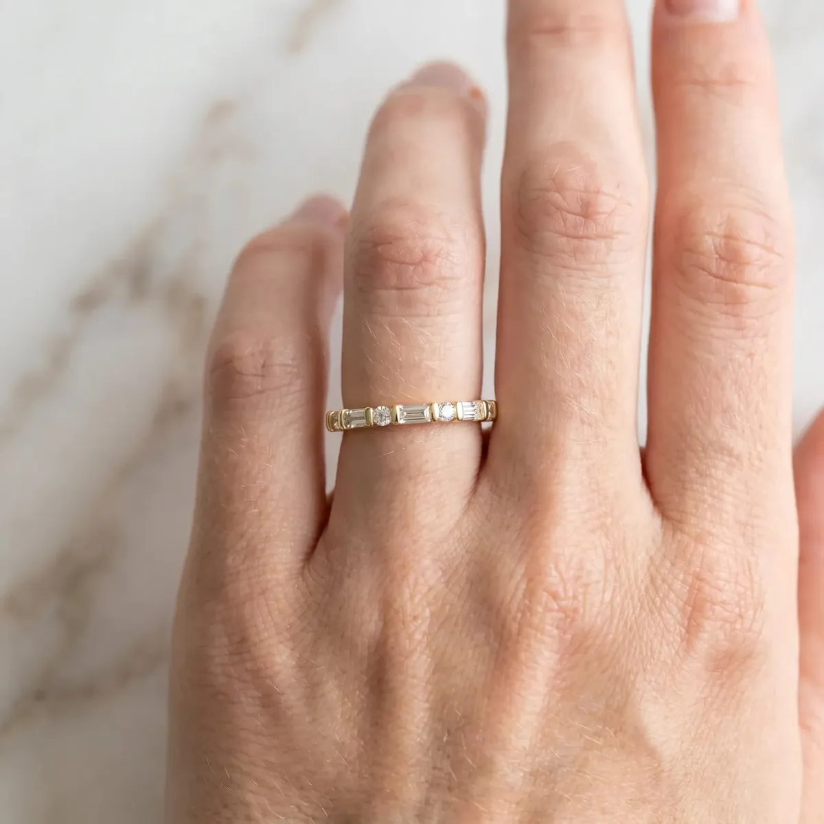 Baguette and Round Diamond Channel Set Half Eternity Band with Bar Prong Setting Yellow gold