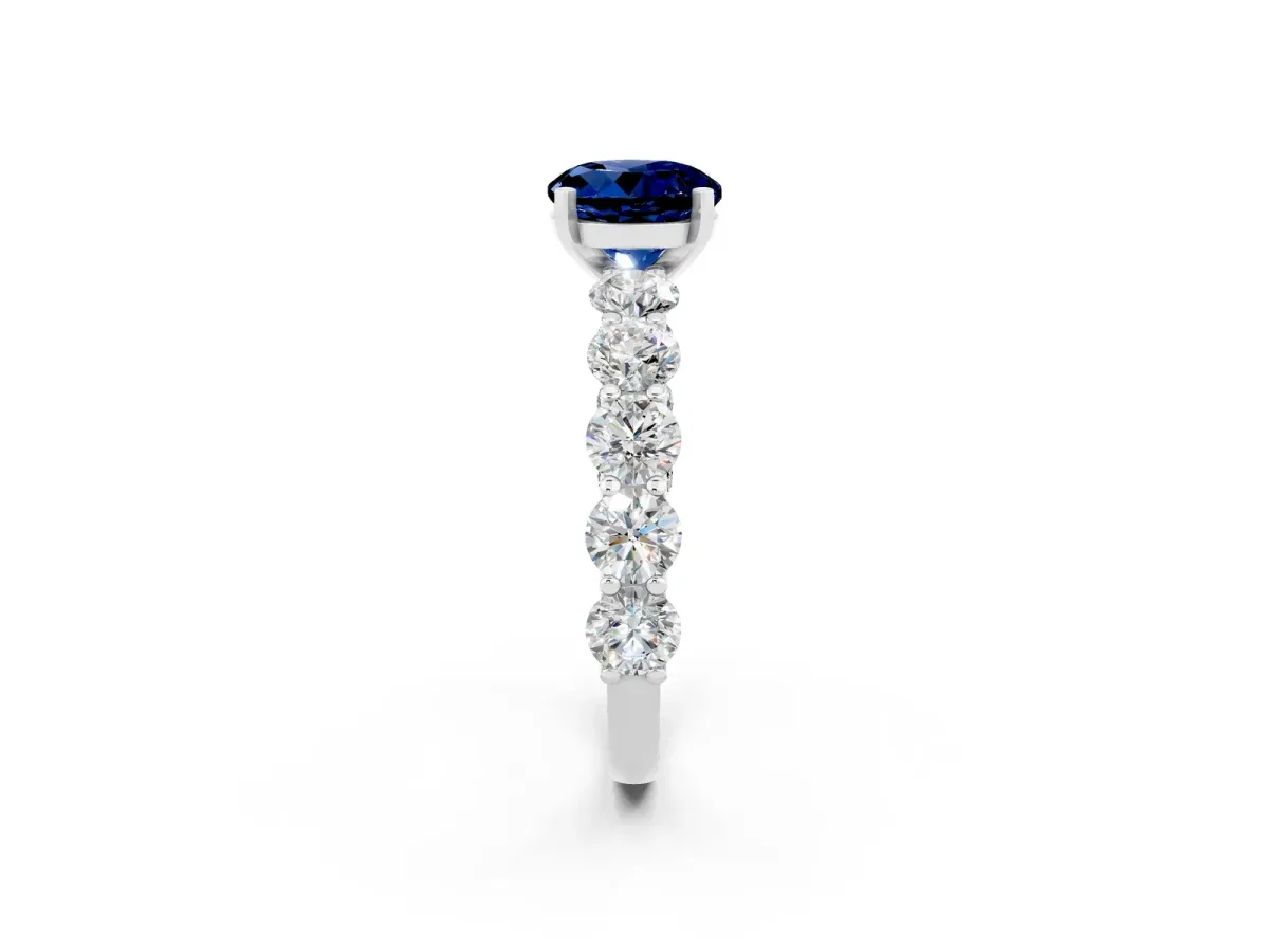 Round Cut Blue Sapphire Prong Setting with Side Stones on a Pave Band Platinum