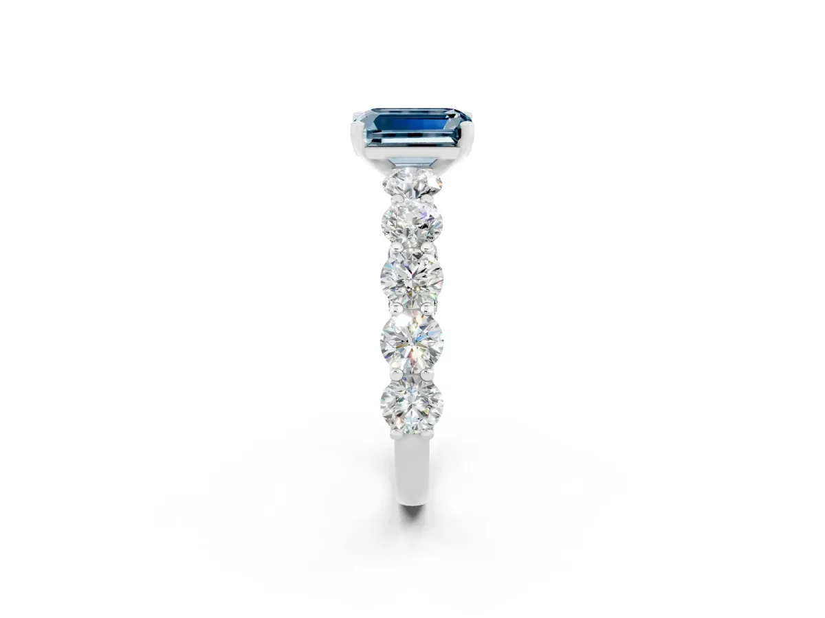 Emerald Cut Aquamarine Prong Setting with Side Stones on a Pave Band Silver