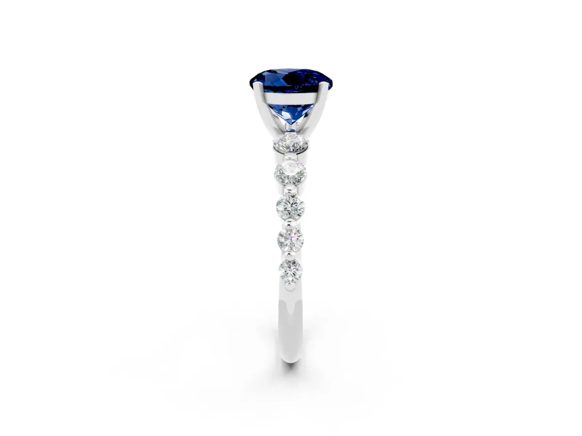 Round Cut Solitaire Blue Sapphire Ring with Pave Band and Four-Prong Setting Silver