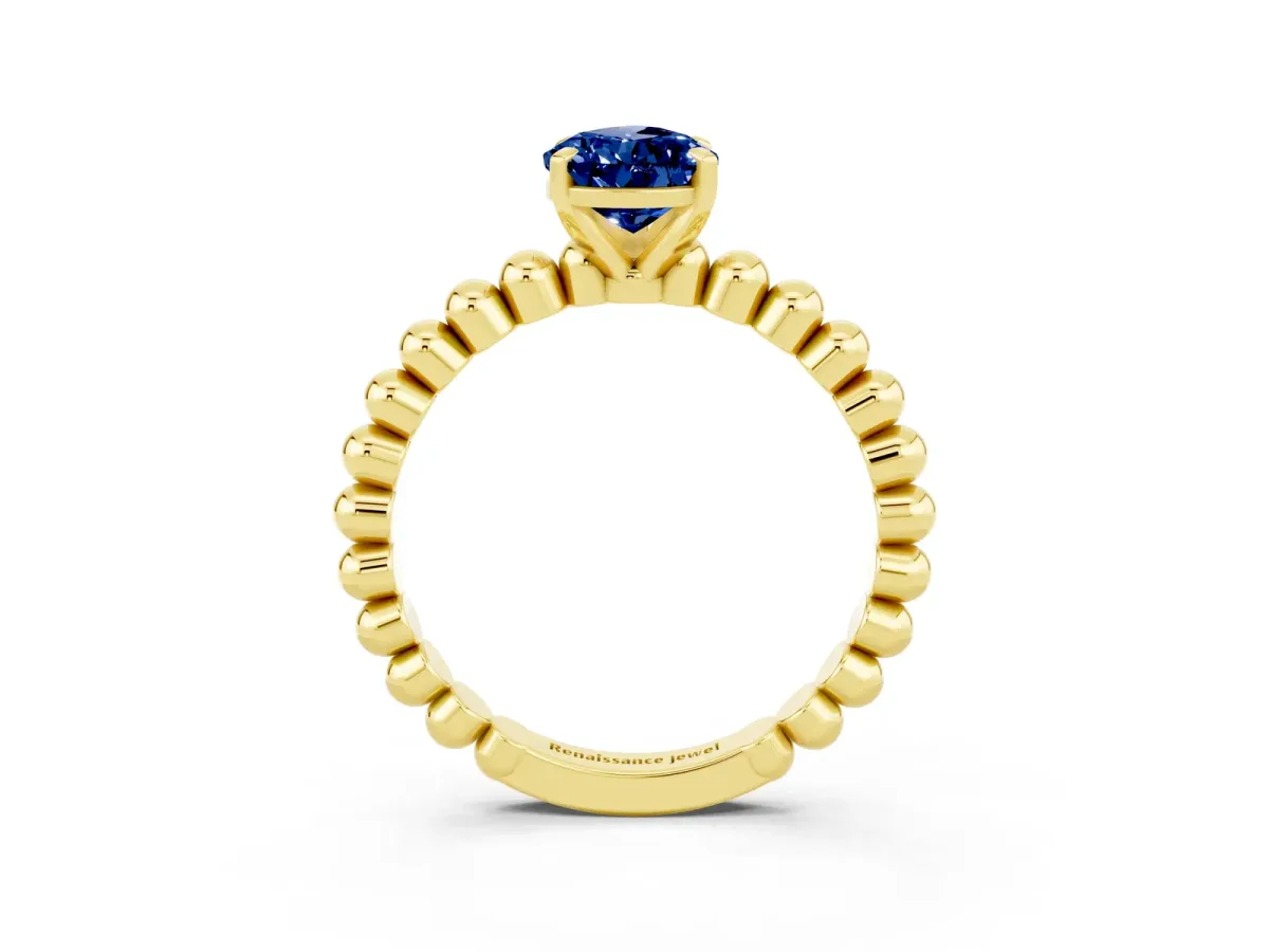 Pear Cut Blue Sapphire Solitaire Ring with Beaded Band and Prong Setting Yellow gold