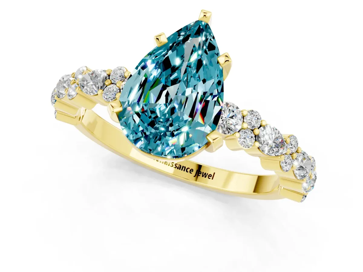 Pear Cut Blue Topaz Side Stone Solitaire Ring with Round and Four-Prong Setting Yellow gold