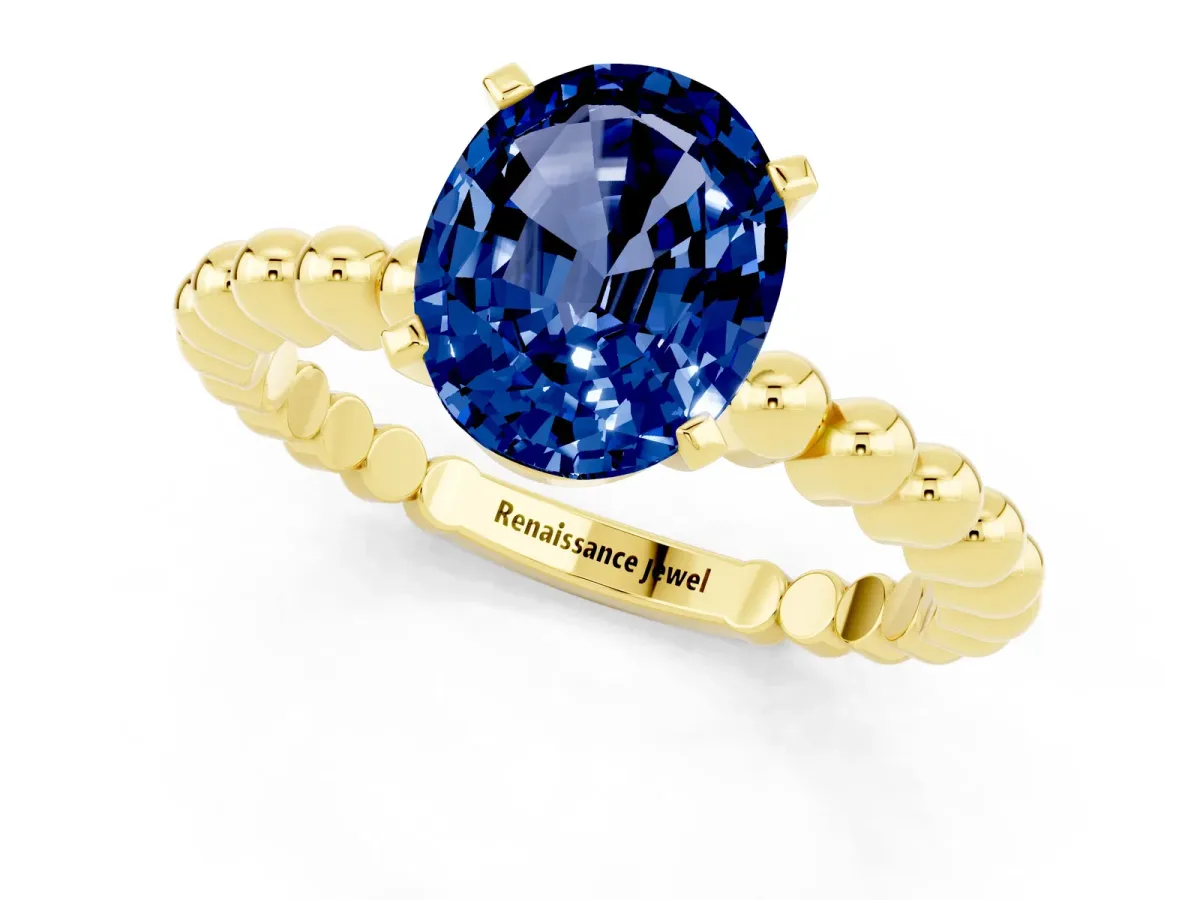 Oval Cut Blue Sapphire Solitaire Ring with Beaded Band and Prong Setting Yellow gold