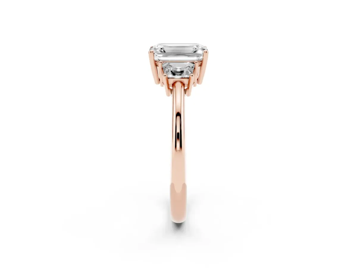 Emerald Cut Diamond Three-Stone Ring with Trapezoid Side Stones and Prong Setting Rose gold