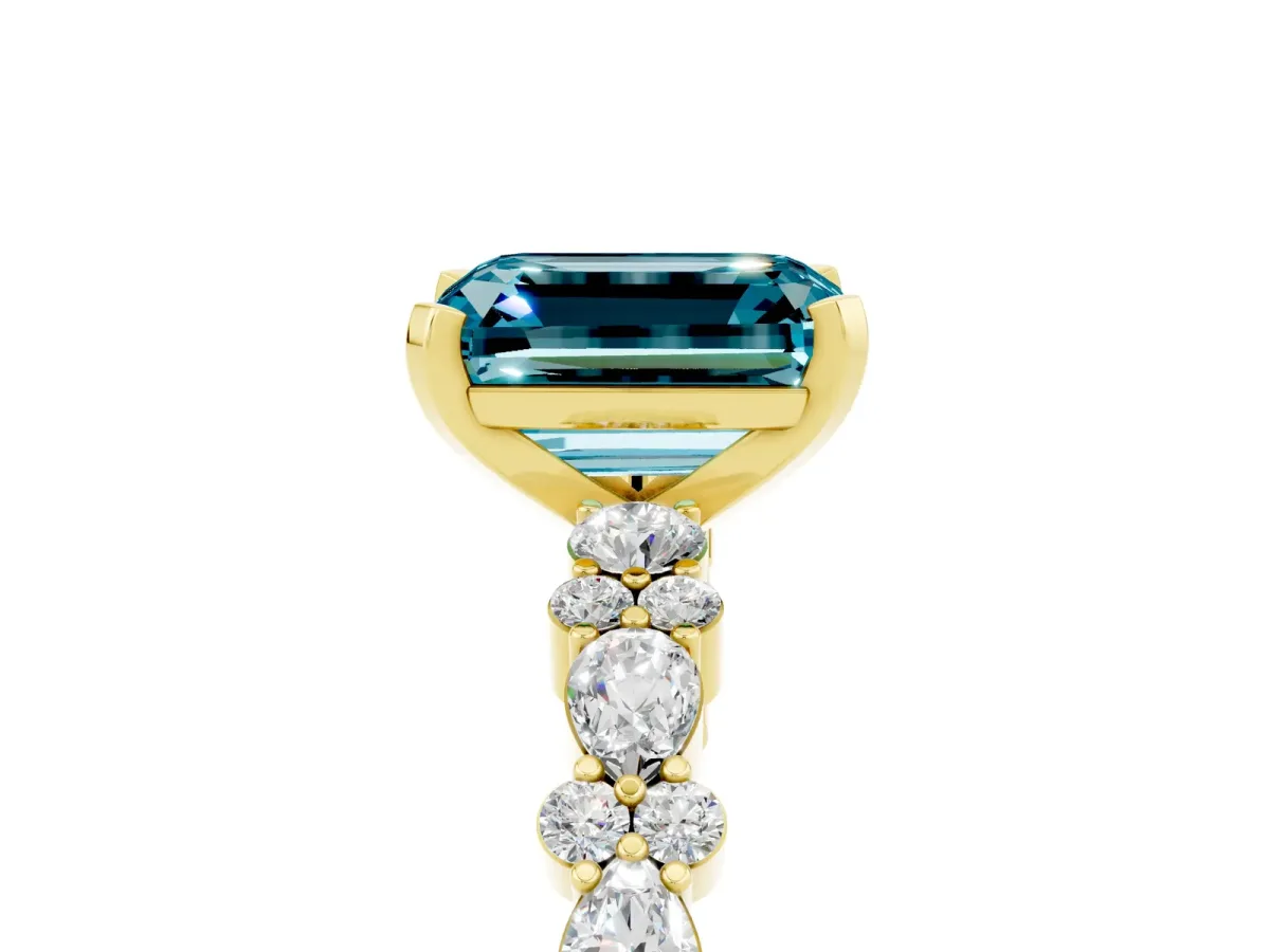 Emerald Cut Blue Topaz Side Stone Solitaire Ring with Round and Four-Prong Setting Yellow gold