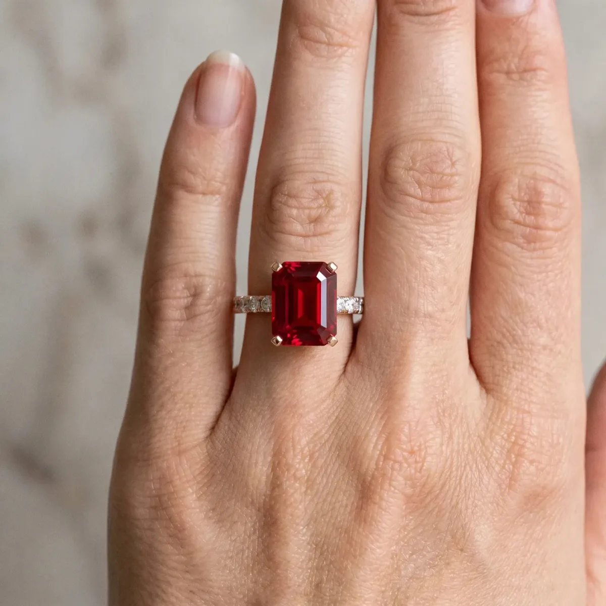 Emerald Cut Ruby Solitaire Ring with Round Pavé Band and Four-Prong Setting Rose gold