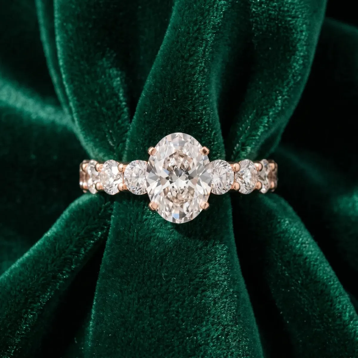Oval Cut Diamond Prong Setting with Side Stones on a Pave Band Rose gold
