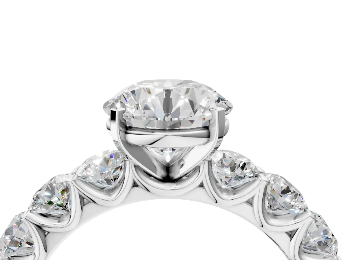 Round Cut Diamond Prong Setting with Side Stones on a Pave Band Platinum