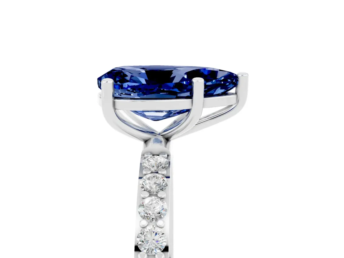 Pear Cut Blue Sapphire Solitaire Ring with Round Pavé Band and Prong Setting Platinum