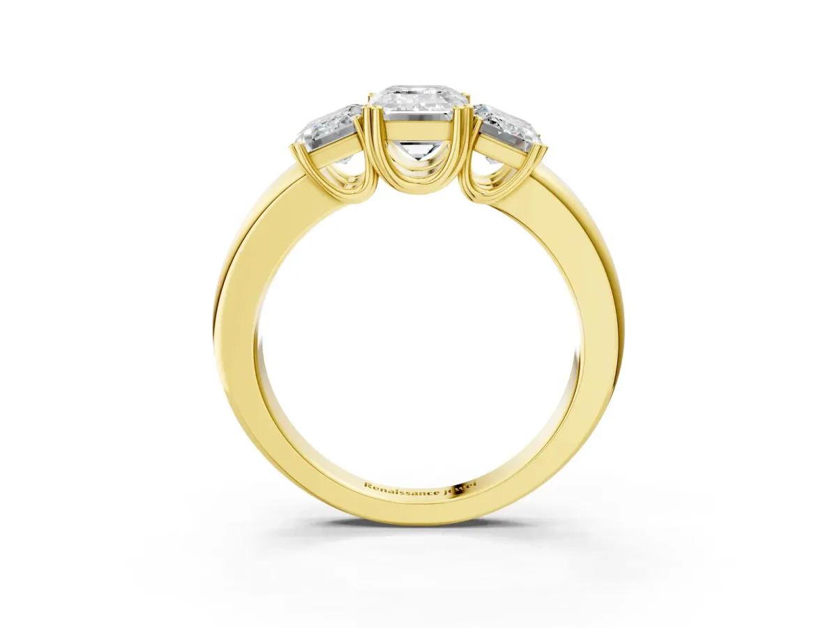 Three-Stone Emerald Cut Cut Diamond Ring with Channel Set Band and Four-Prong Setting Yellow gold