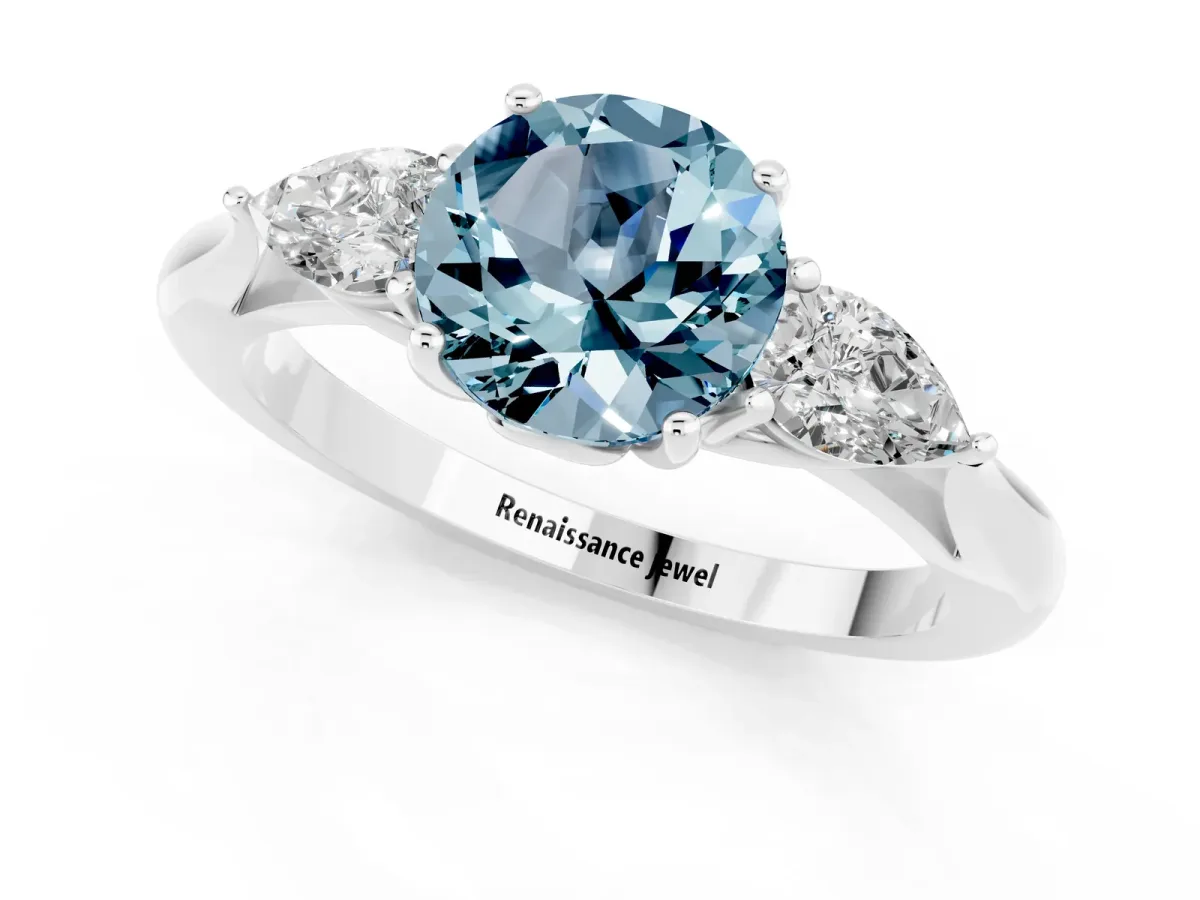 Three-Stone Round Cut Aquamarine Ring with Pear Side Stones in Four-Prong Setting Platinum