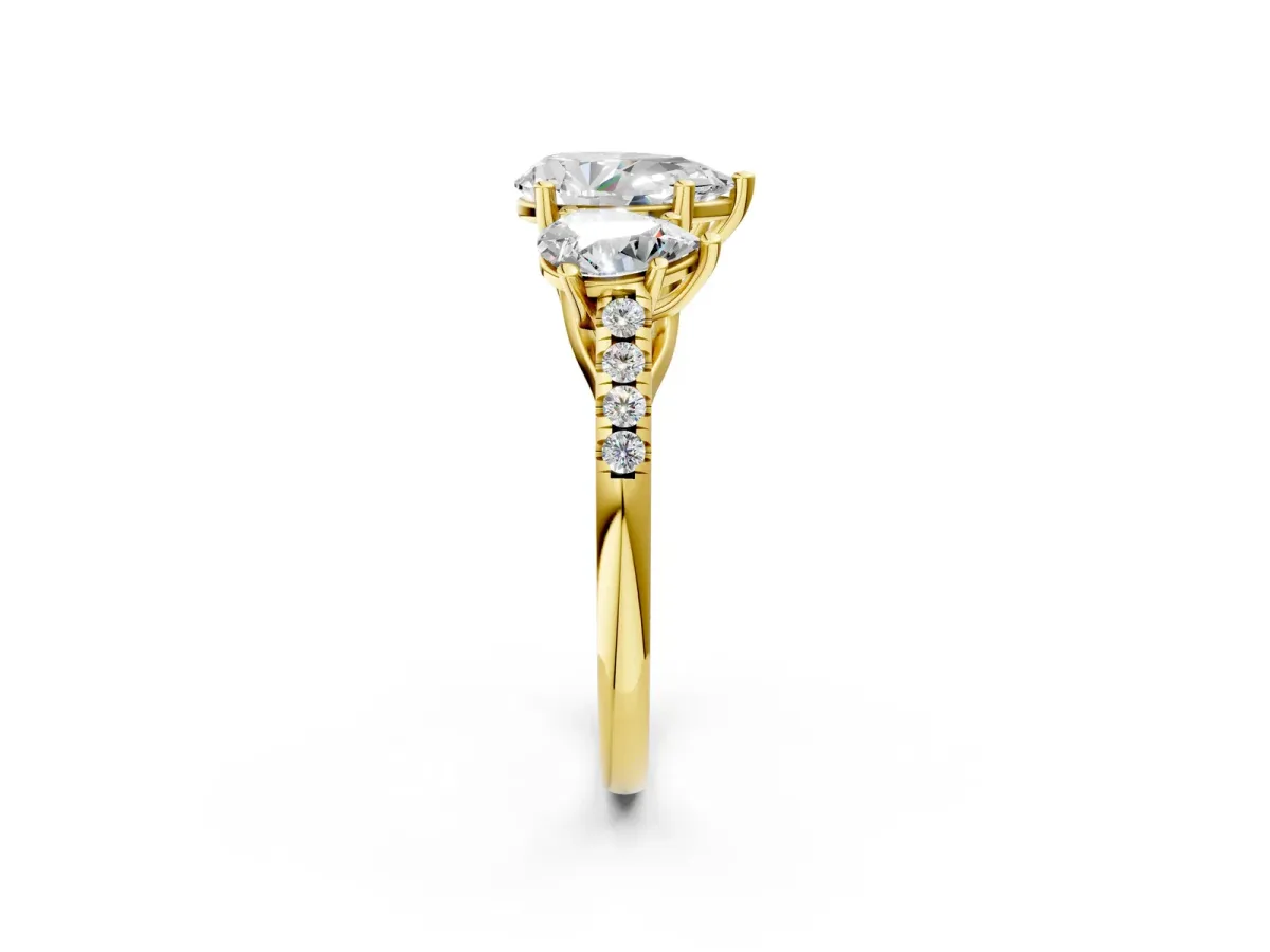 Three-Stone Pear Cut Diamond Ring with Round Pavé Band and Prong Setting Yellow gold