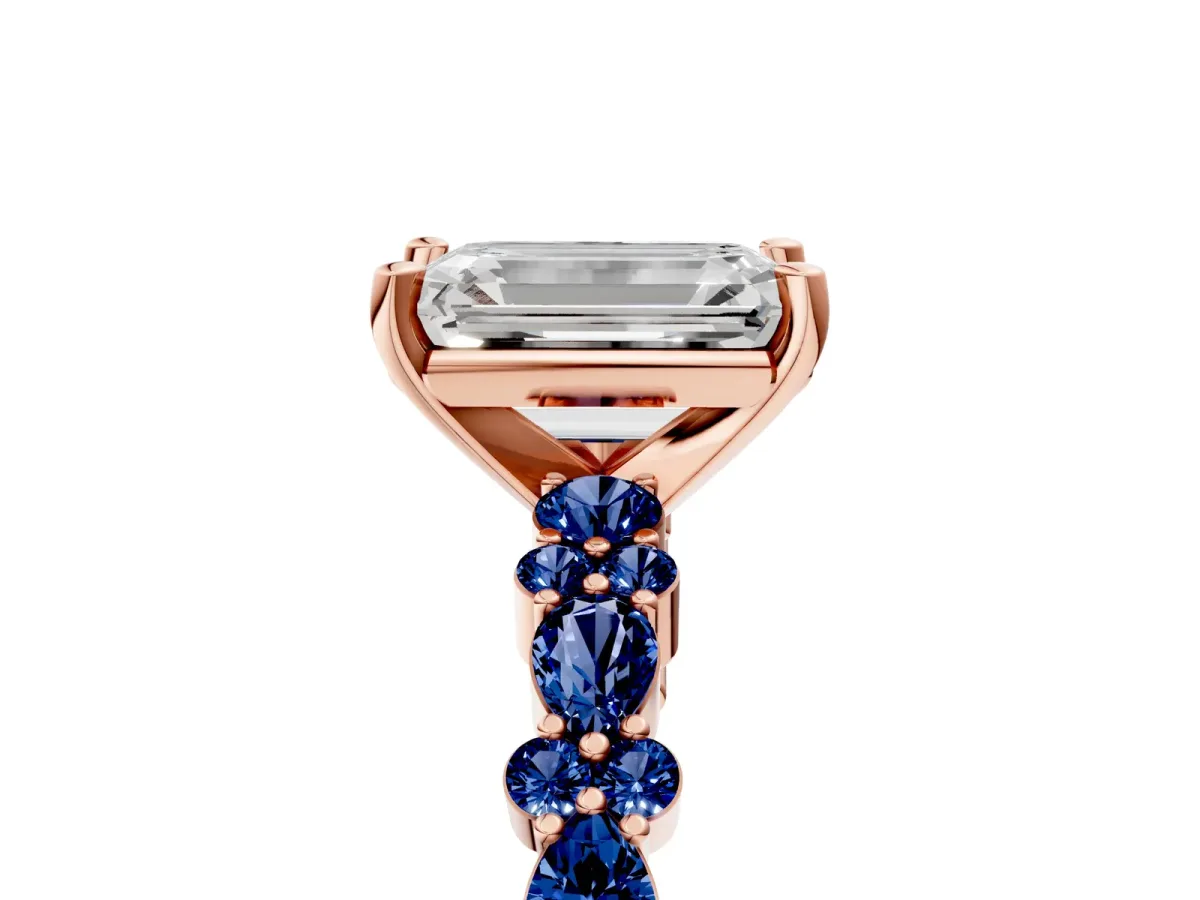 Emerald Cut Diamond Side Stone Solitaire Ring with Round Blue Sapphire and Four-Prong Setting Rose gold