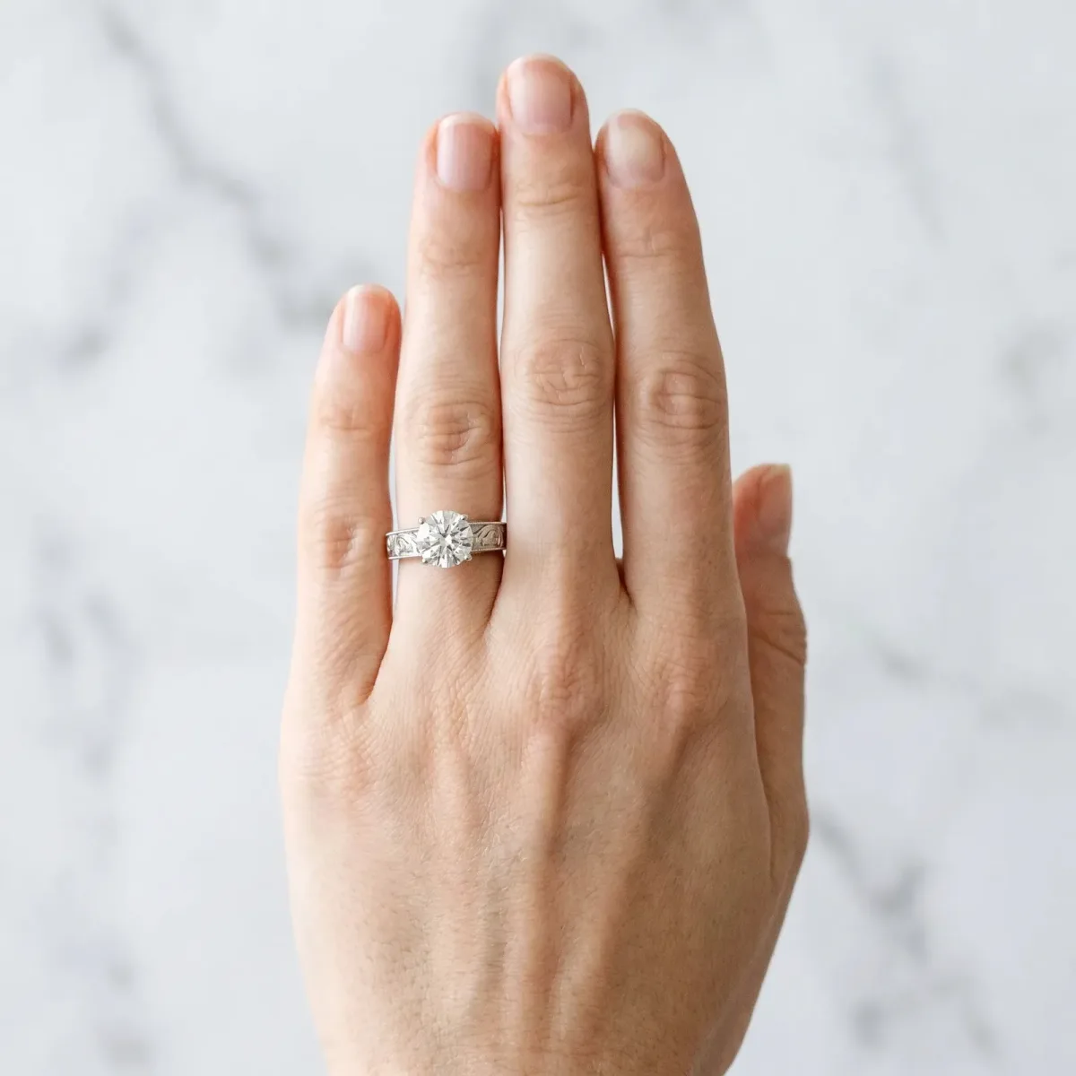 Round Cut Diamond Solitaire Ring with Engraved Band and Four-Prong Setting White gold