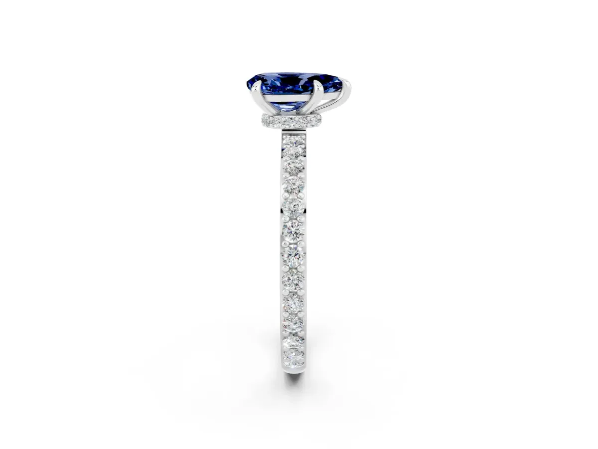 Pear Cut Blue Sapphire Solitaire Engagement Ring with Pavé Band and Four-Prong Setting Silver