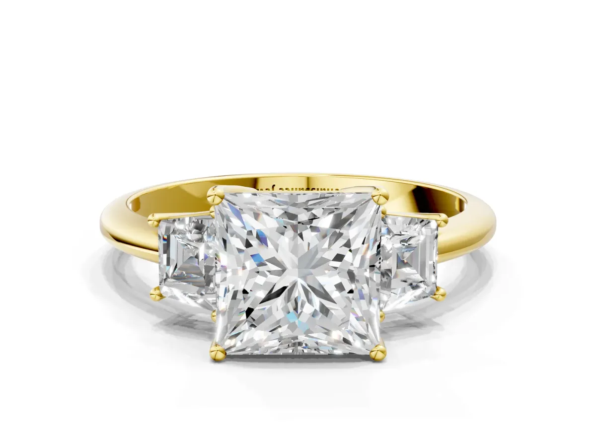 Princess Cut Diamond Three-Stone Ring with Trapezoid Side Stones and Prong Setting Yellow gold
