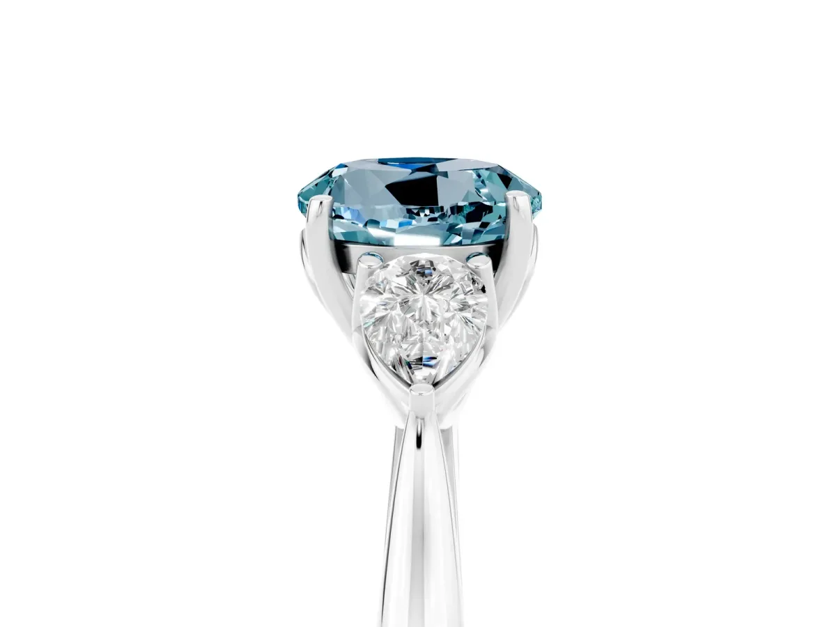 Three-Stone Round Cut Aquamarine Ring with Pear Side Stones in Four-Prong Setting Platinum
