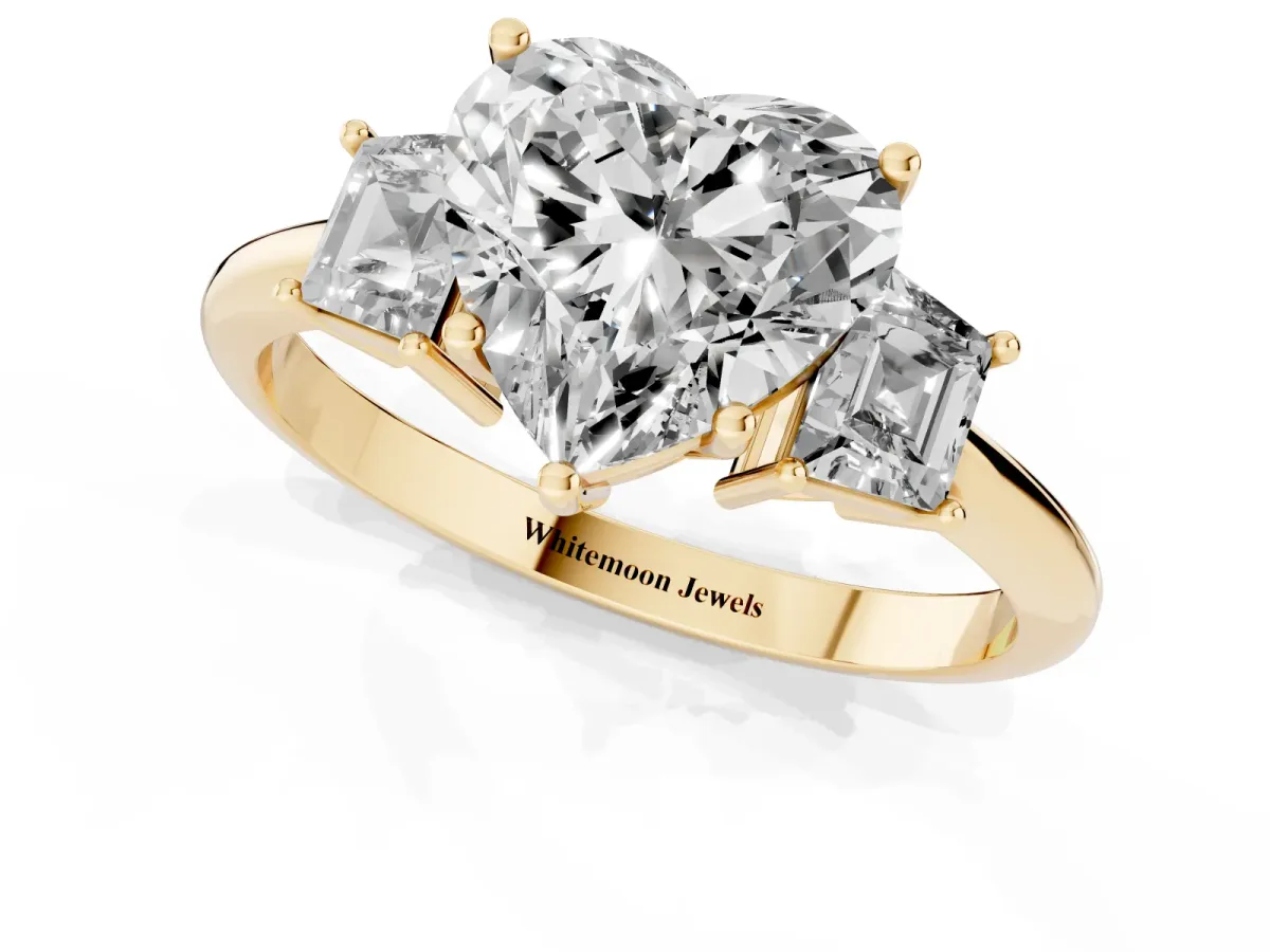 Heart Cut Diamond Three-Stone Ring with Trapezoid Side Stones and Prong Setting Yellow gold