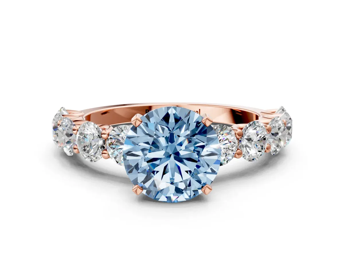 Fancy Blue Round Cut Diamond Prong Setting with Side Stones on a Pave Band Rose gold