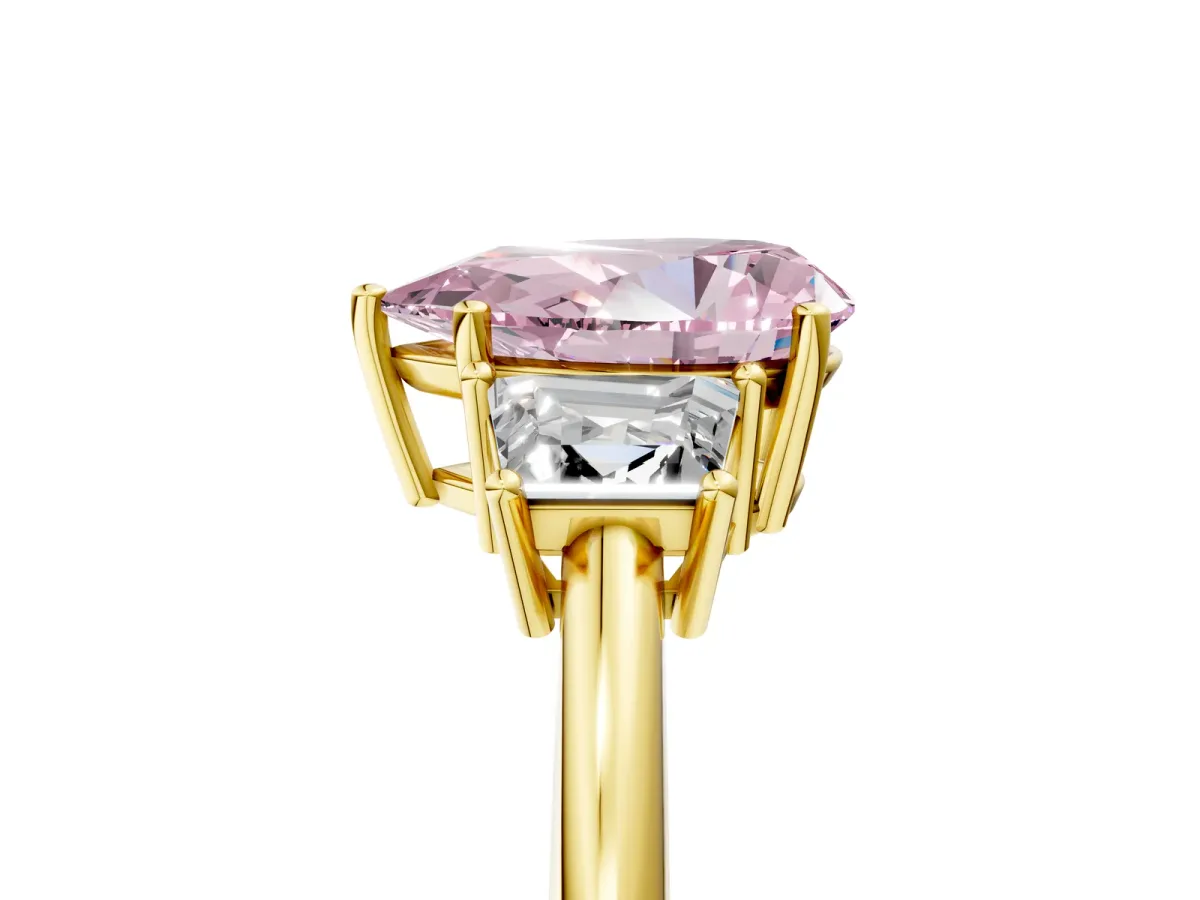 Fancy Pink Pear Cut Diamond Three-Stone Ring with Trapezoid Side Stones and Prong Setting Yellow gold