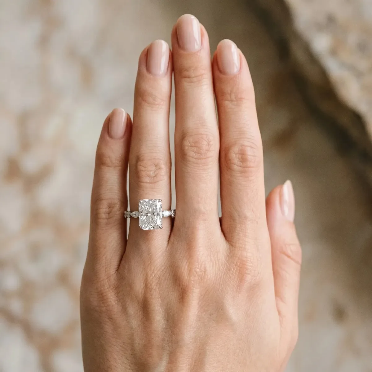 Radiant Cut Diamond Ring with Marquise and Round Side Stones and Four-Prong Setting Silver
