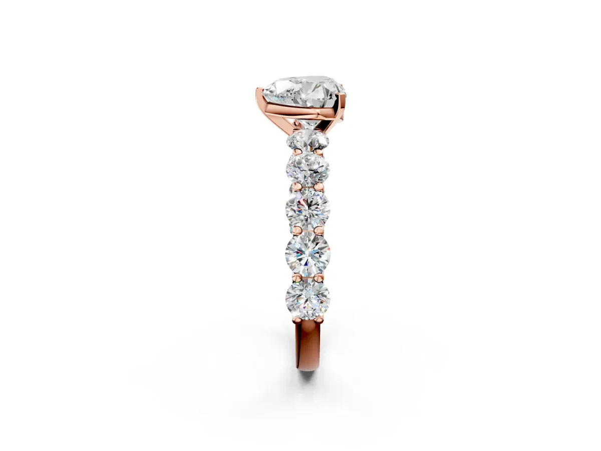 Heart Cut Diamond Prong Setting with Side Stones on a Pave Band Rose gold