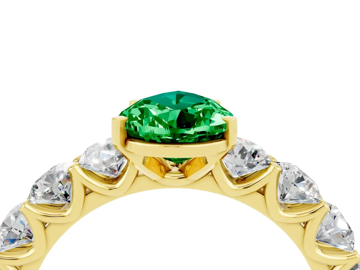 Pear Cut Emerald Prong Setting with Side Stones on a Pave Band Yellow gold