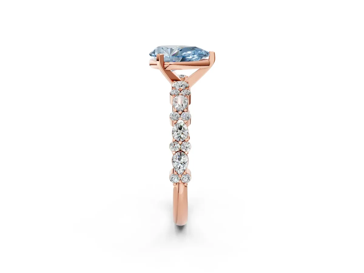 Fancy Blue Pear Cut Diamond Side Stone Solitaire Ring with Round and Four-Prong Setting Rose gold