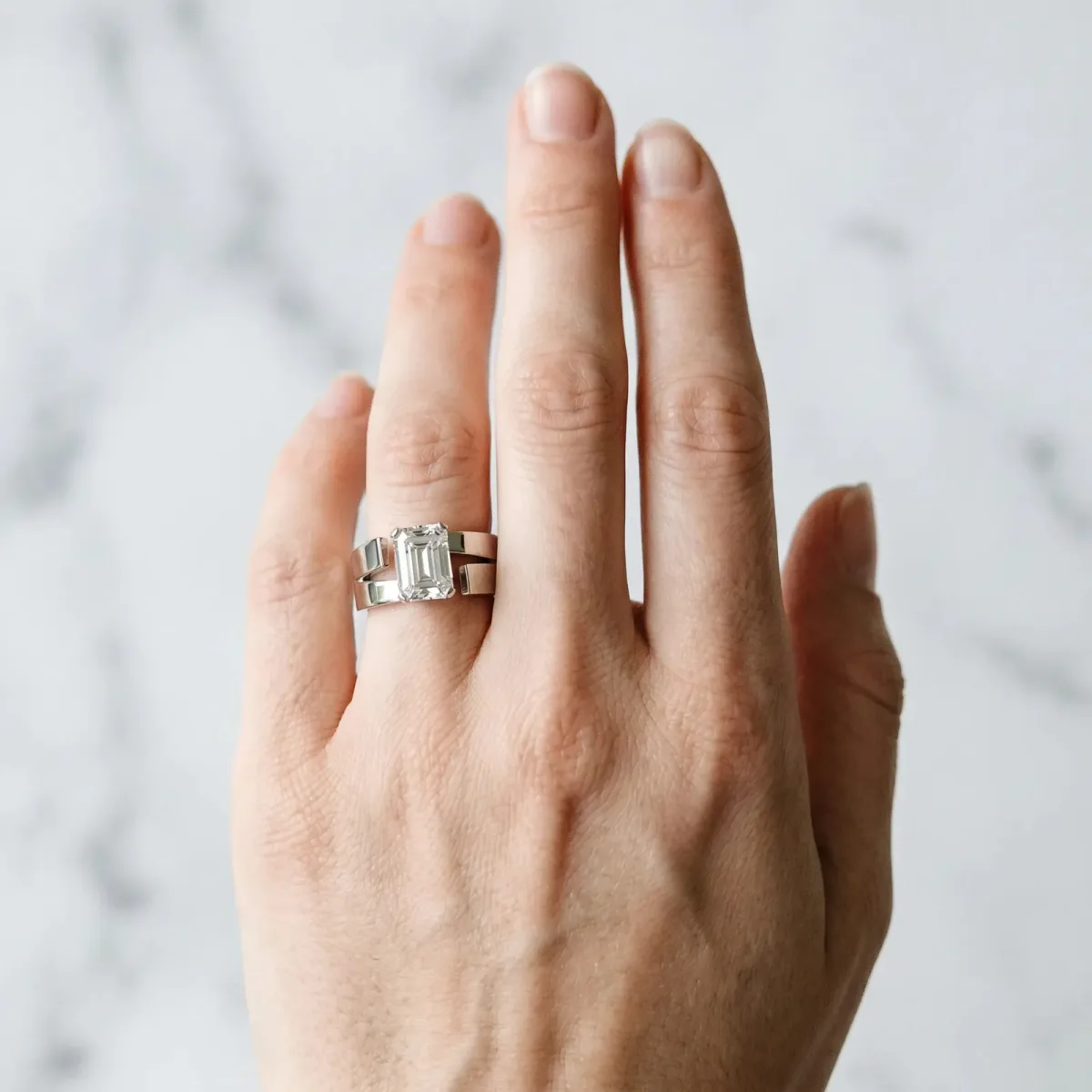 Modern Tension Set Emerald Cut Diamond Solitaire Wide Band Ring Platinum