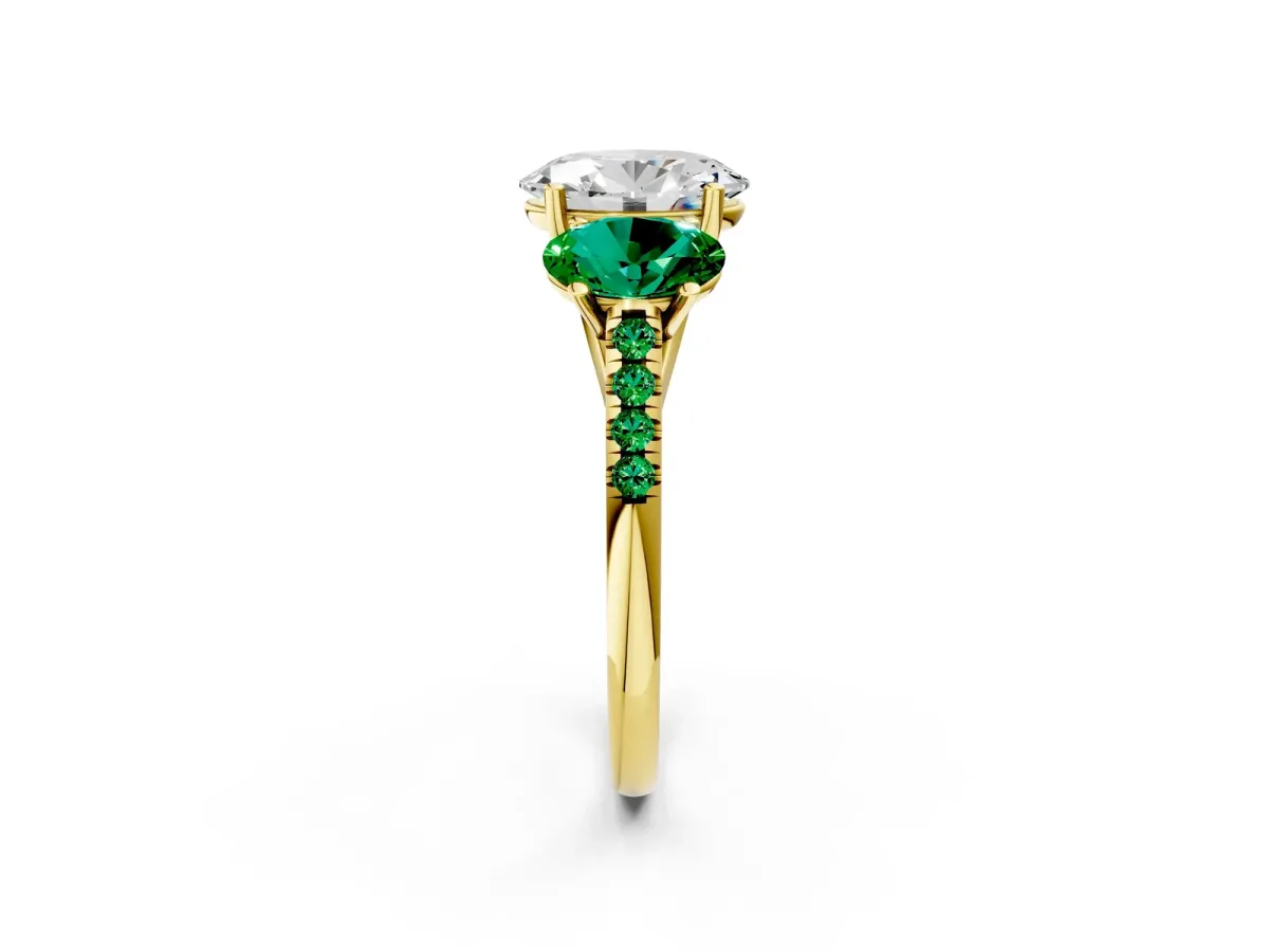 Three-Stone Oval Cut Diamond Ring with Round Emerald Pavé Band and Prong Setting Yellow gold