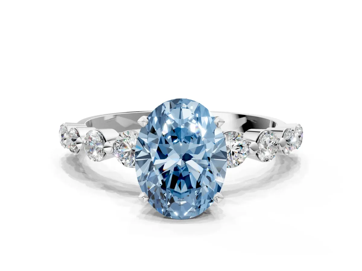 Fancy Blue Oval Cut Solitaire Diamond Ring with Pave Band and Four-Prong Setting Silver