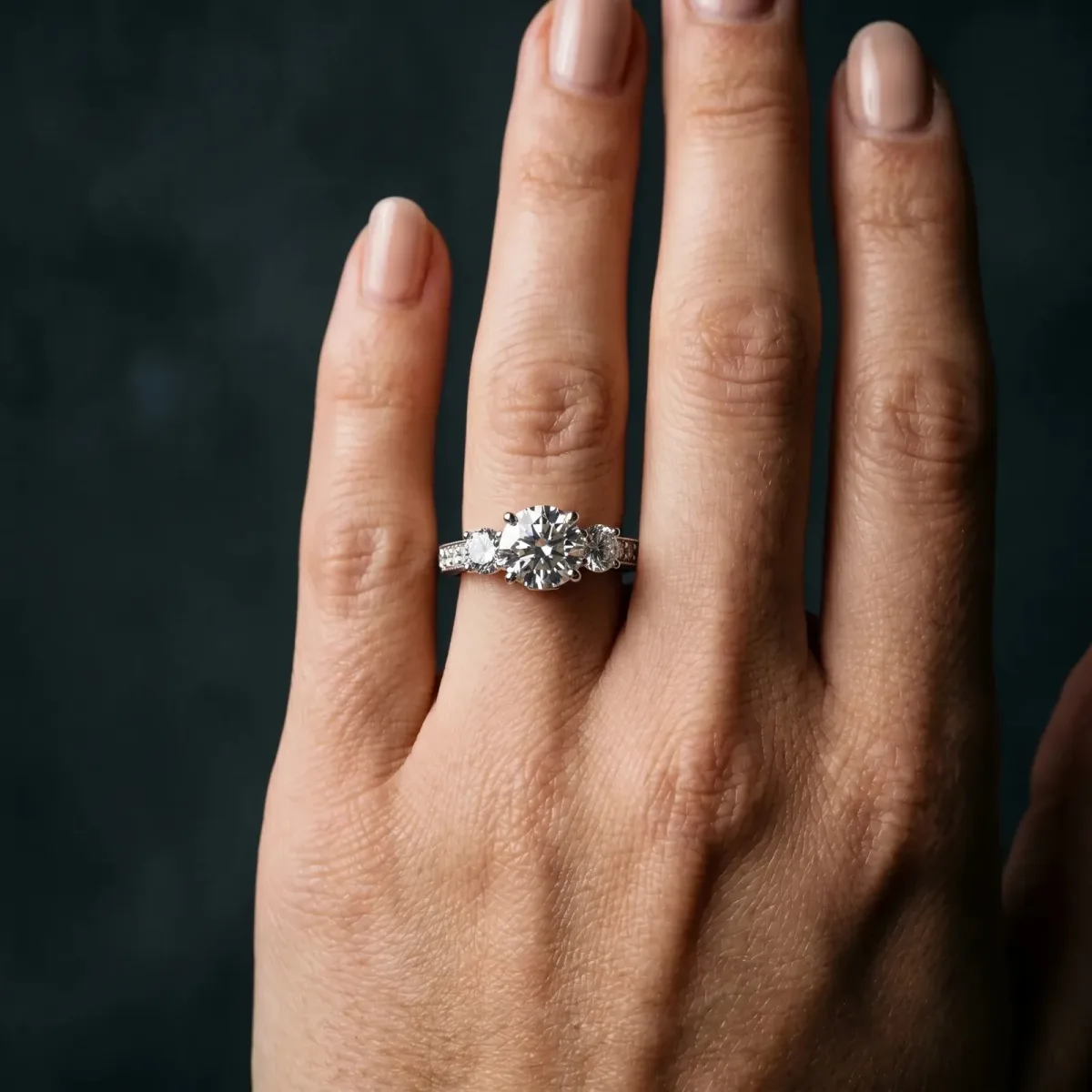Three-Stone Round Cut Cut Diamond Engagement Ring with Split Shank and Prong Setting Platinum