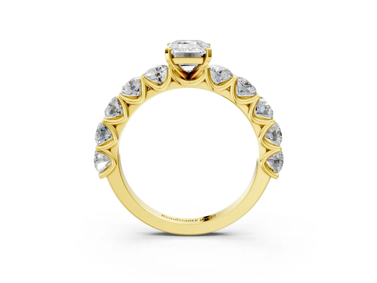 Emerald Cut Diamond Prong Setting with Side Stones on a Pave Band Yellow gold