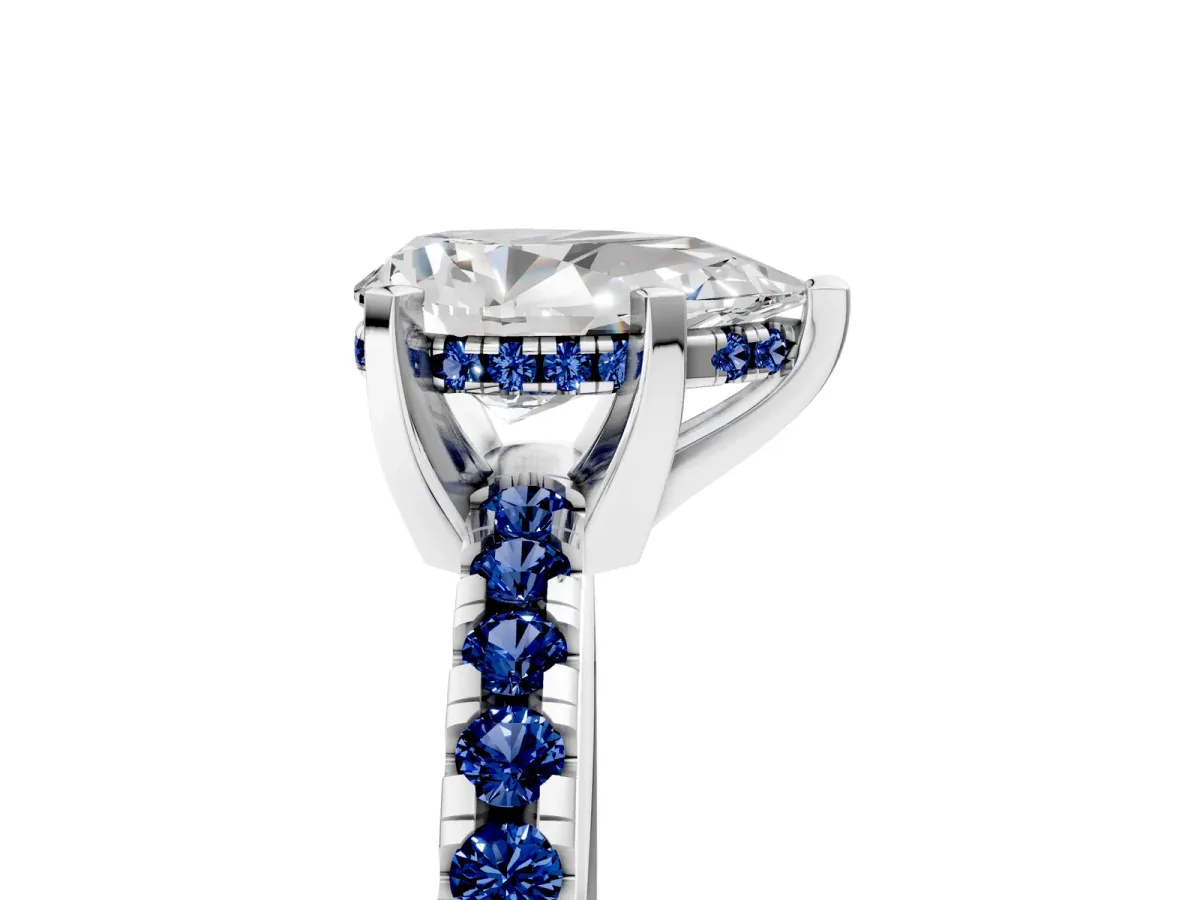 Pear Cut Diamond Solitaire Ring with Round Blue Sapphire Pavé Band and Four-Prong Setting Silver