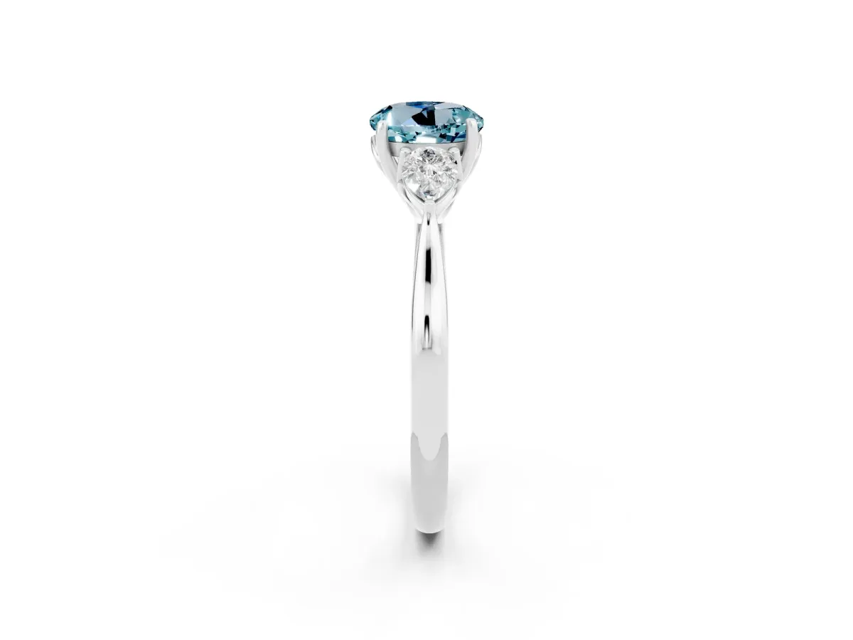 Three-Stone Round Cut Aquamarine Ring with Pear Side Stones in Four-Prong Setting Platinum