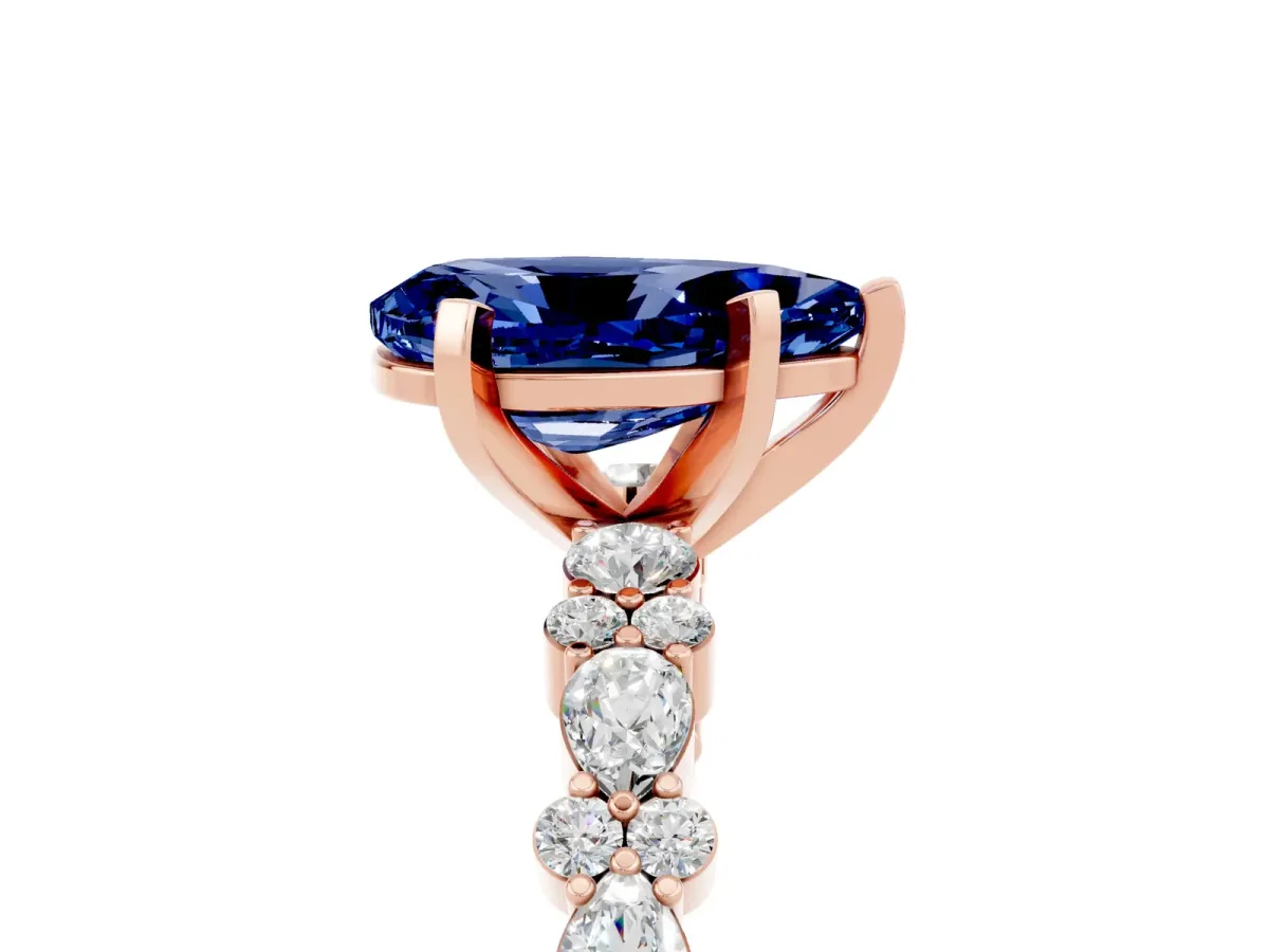 Pear Cut Blue Sapphire Side Stone Solitaire Ring with Round and Four-Prong Setting Rose gold
