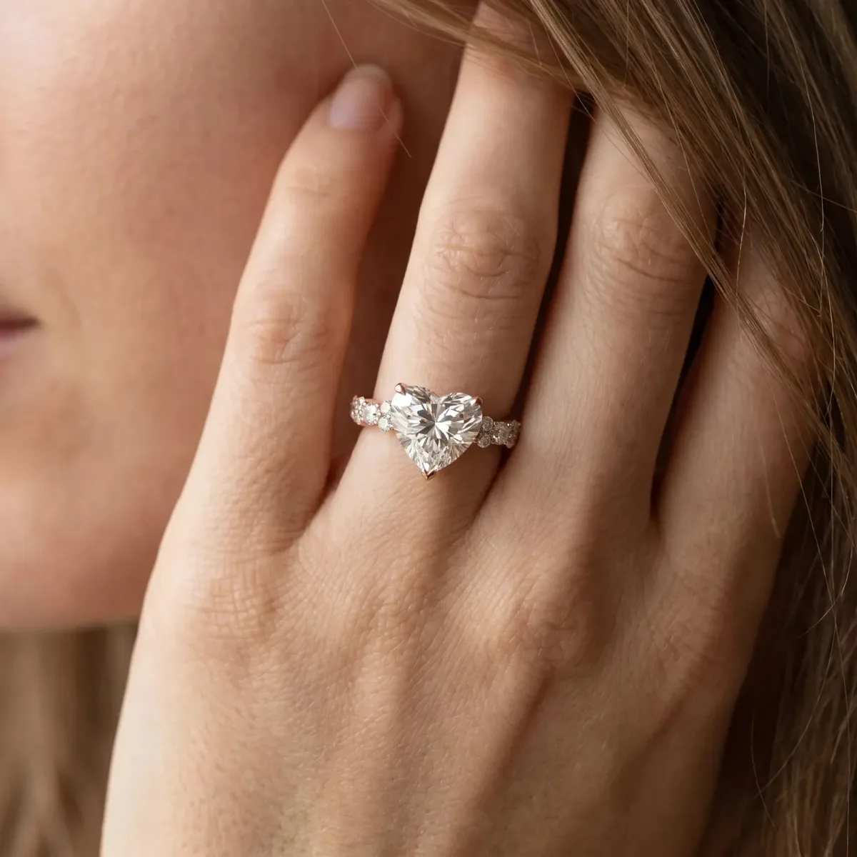 Heart Cut Diamond Side Stone Solitaire Ring with Round and Four-Prong Setting Rose gold
