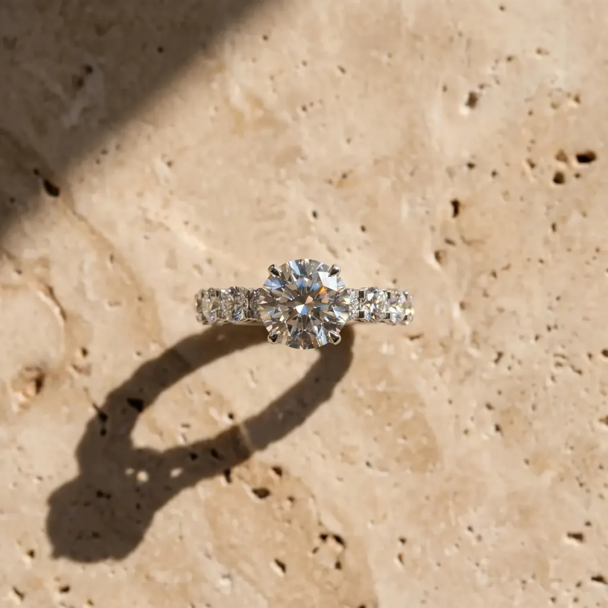 Round Cut Diamond Side Stone Engagement Ring with Four-Prong Setting Platinum