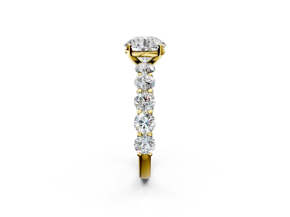 Round Cut Diamond Prong Setting with Side Stones on a Pave Band Yellow gold