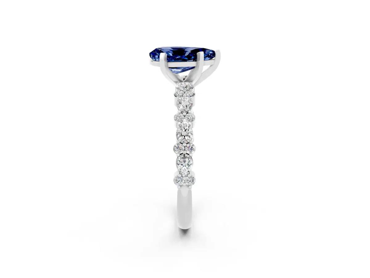 Pear Cut Blue Sapphire Side Stone Solitaire Ring with Round and Four-Prong Setting White gold