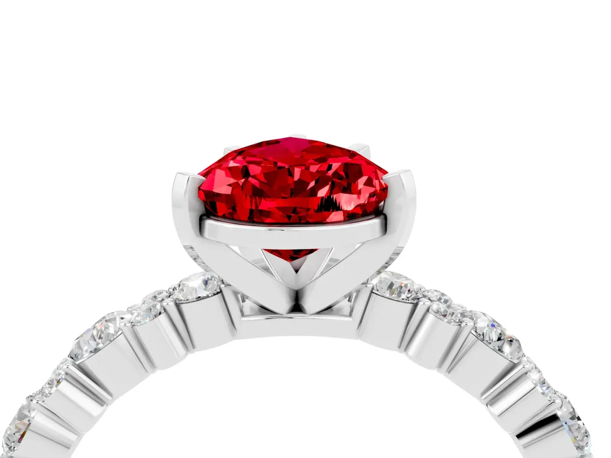 Pear Cut Ruby Side Stone Solitaire Ring with Round and Four-Prong Setting White gold