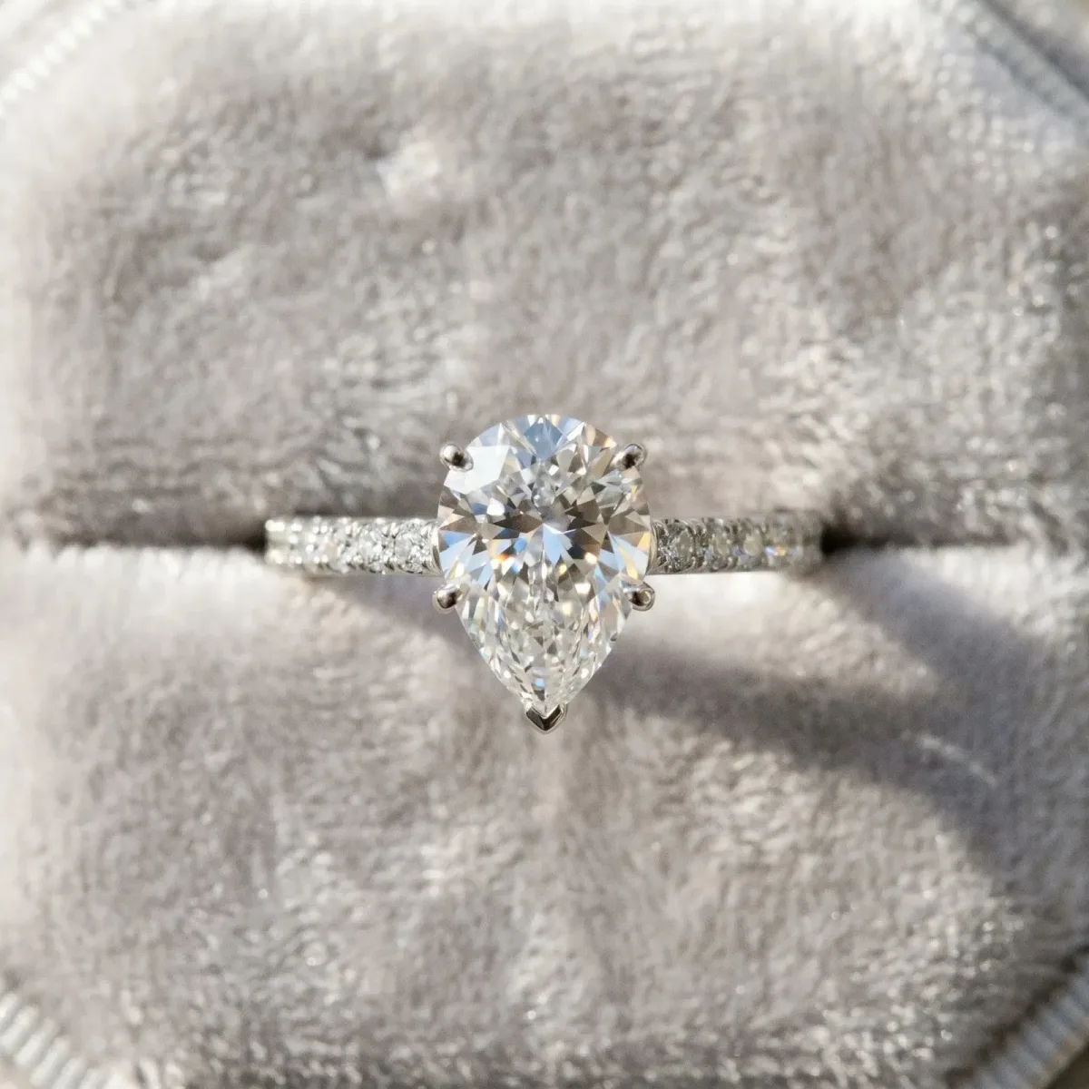 Pear Cut Cut Solitaire Diamond Engagement Ring with Pave Band and Four-Prong Setting Silver