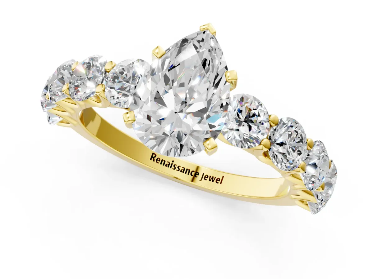 Pear Cut Diamond Prong Setting with Side Stones on a Pave Band Yellow gold