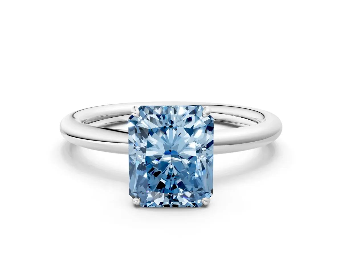 Fancy Blue Radiant Cut Solitaire Diamond Ring with Four-Prong Setting on a Plain Band Platinum
