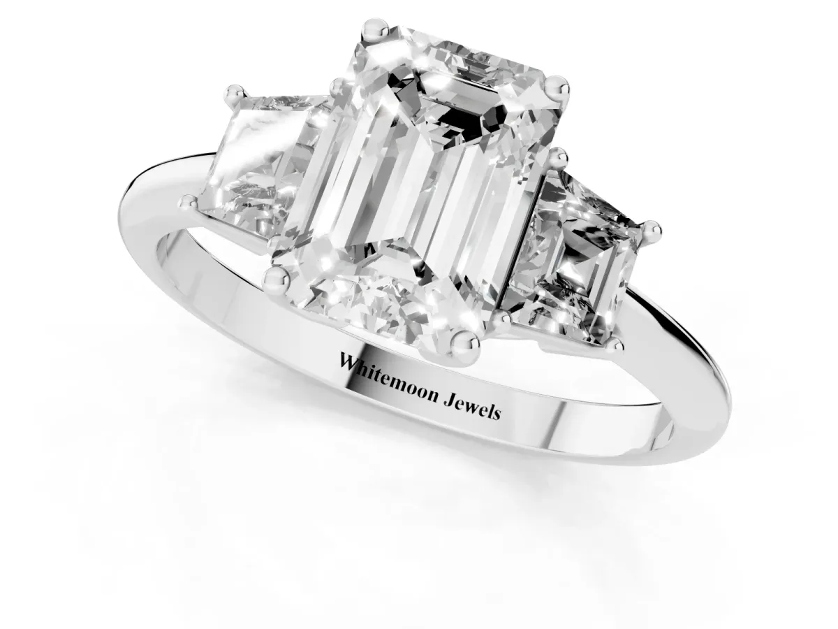 Emerald Cut Diamond Three-Stone Ring with Trapezoid Side Stones and Prong Setting White gold